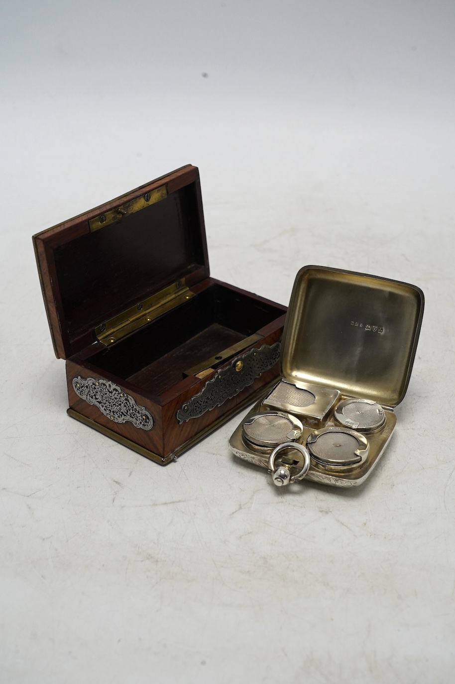 An Edwardian engraved silver combination sovereign/half sovereign and stamp case, E.J. Trevitt & Sons, Chester, 1901, 57mm and a white metal mounted kingwood snuff box. Condition - fair to good